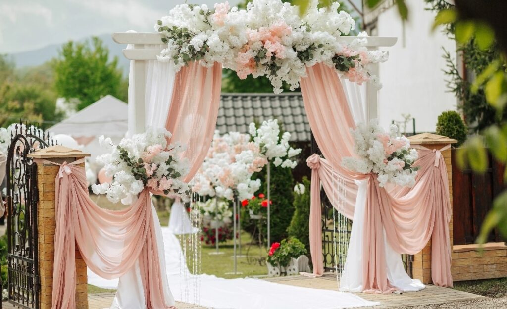 wedding-ceremony-is-taking-place-garden-with-white-archway